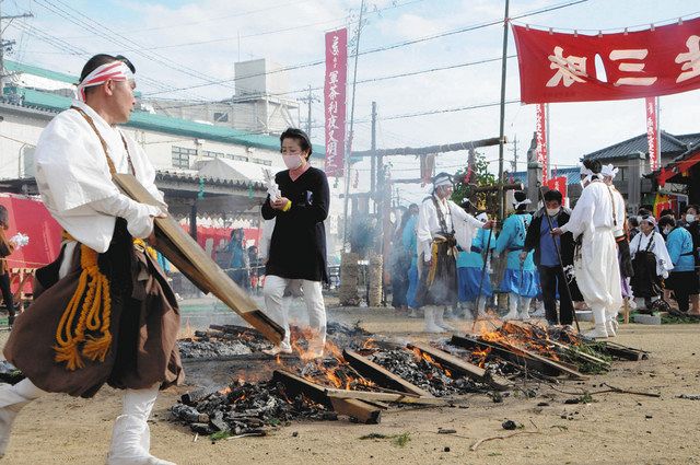 木が燃えた跡を渡る参加者＝豊橋市仁連木町の観真寺で 