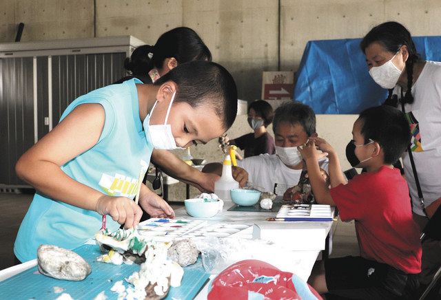 木や石を組み合わせて造形作品を作る参加者ら＝多治見市東町の県現代陶芸美術館で 