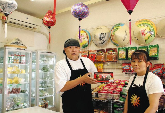 店内を紹介する宮川さん（左）グエンさん夫妻。装飾は友人が手伝った＝垂井町垂井の「ニャットズン」で