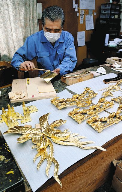 金箔を使用して行われる仏壇の装飾品の箔押し作業。金相場の高止まりで、影響が懸念されている＝金沢市で

