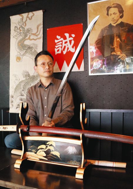 芹沢鴨が所有していた可能性のある日本刀を手にする佐藤さん＝松本市で
