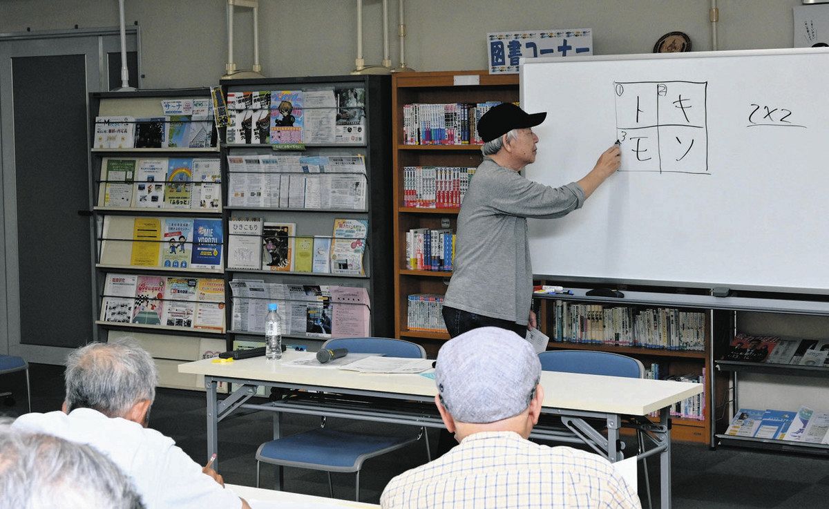 クロスワードパズルの作成方法を教える藤木さん＝津市のアスト津で
