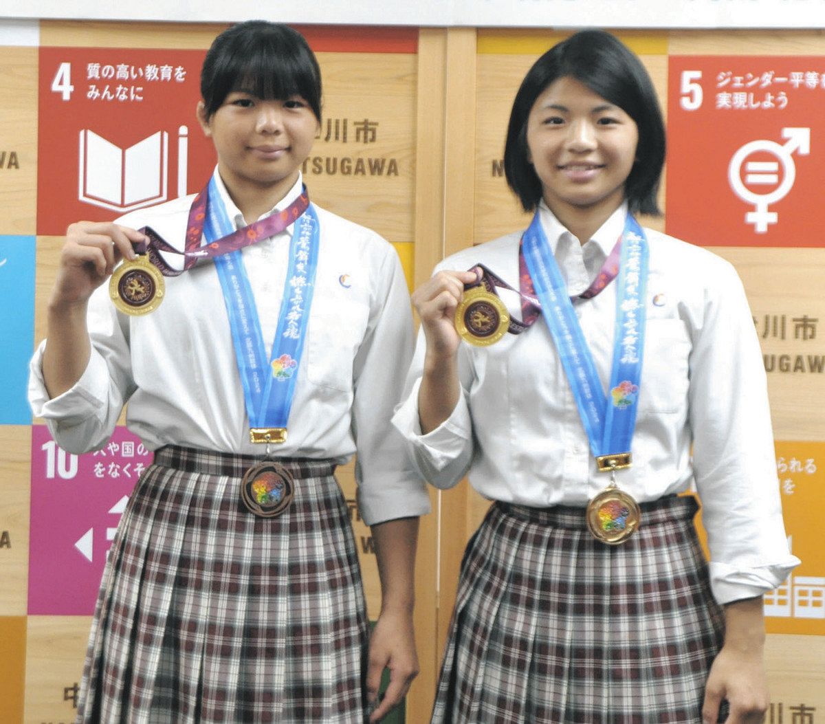 メダルを手にほほ笑む小川凜佳さん（右）、璃苑さん＝中津川市役所で