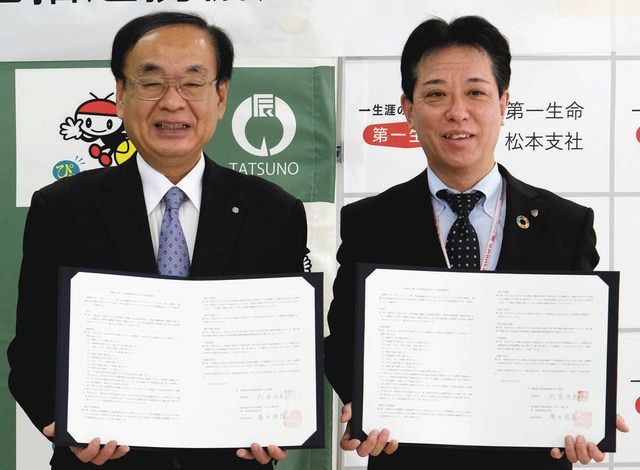 協定書に調印した武居町長と勝田支社長（右）＝辰野町役場で