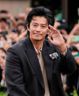 パレードで沿道の人たちに手を振る俳優の小栗旬さん