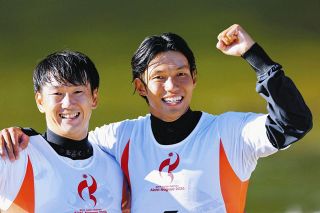 男子カヤッククロスで、金メダルを獲得しガッツポーズの田中選手（右）＝愛知県の矢作川カヌースラロームコースで